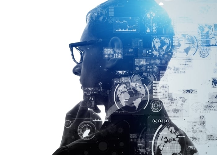 a Person in Profile Wearing Glasses Thoughtfully Touching Their Chin Overlaid with Digital Data Graphics Charts and World Maps Suggesting Concepts of Technology Innovation and Analysis