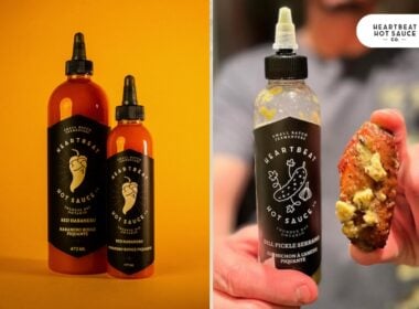 Two bottles of Heartbeat Hot Sauce with black labels are displayed on the left against an orange background. On the right, a hand holds a chicken wing next to an open bottle of Heartbeat Hot Sauce with a black label.