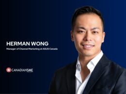 a Man in a Dark Suit Poses and Smiles in Front of a Blue Background Text Reads herman Wong Manager of Channel Marketing at Asus Canada the Canadiansme Logo Appears at the Bottom Left