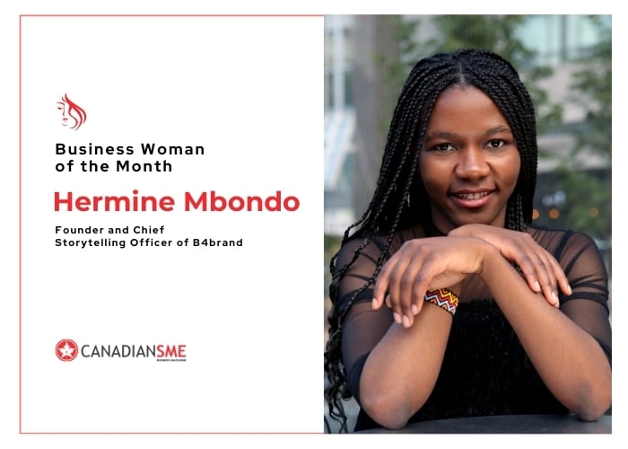A woman with long braided hair sits outdoors, smiling and resting her arms on a table. The text reads Business Woman of the Month Hermine Mbondo, Founder and Chief Storytelling Officer of B4brand. Canadian SME logo is shown.