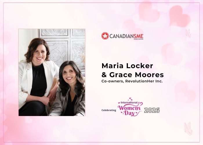 Two women sit smiling in a bright room. The image features text: Maria Locker & Grace Moores, Co-owners, RevolutionHer Inc. Celebrating International Women’s Day 2026, with CanadianSME branding and pink accents.
