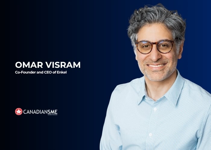 A man with gray curly hair and glasses smiles in front of a dark blue background. Text reads: Omar Visram, Co-Founder and CEO of Enkel. The CanadiansSME logo appears in the lower left corner.
