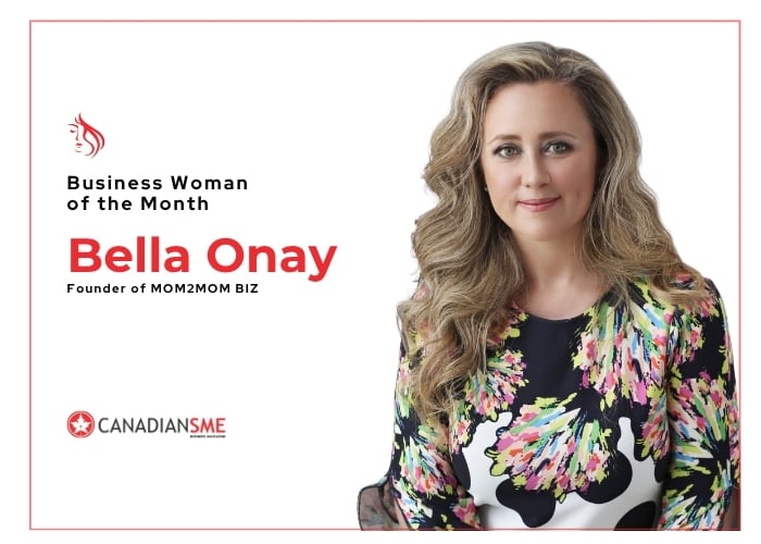 A woman with long wavy hair wearing a floral dress sits against a white background. Text reads: Business Woman of the Month, Bella Onay, Founder of MOM2MOM BIZ. CanadianSME logo is in the corner.